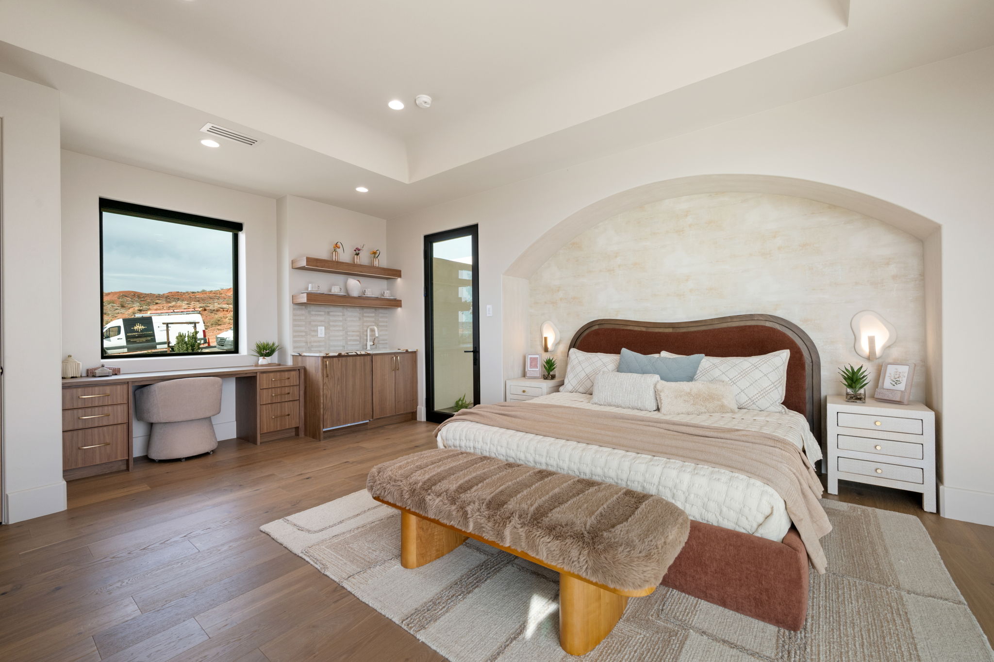 Bedroom featuring built in study area, wood-type flooring, a tray ceiling, and recessed lighting