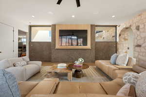 Living area featuring ceiling fan, wood finished floors, and recessed lighting