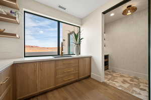Bathroom featuring vanity, dark wood-type flooring, and recessed lighting