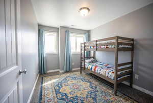 Bedroom featuring baseboards and carpet flooring
