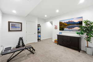 Workout area with light colored carpet and recessed lighting
