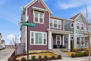 View of front of house with board and batten siding and a porch