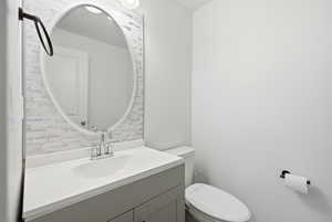 Half bath featuring vanity and toilet