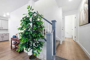 Hall featuring light wood-style flooring and recessed lighting