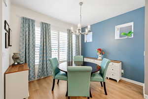Dining room with a chandelier and light wood-style flooring