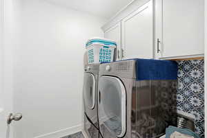 Laundry area with cabinet space and independent washer and dryer