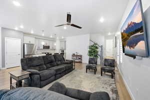 Living area featuring a ceiling fan, light wood-style flooring, and recessed lighting