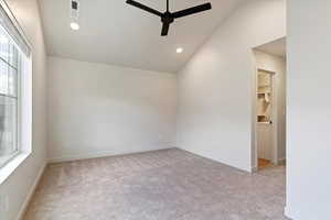Spare room with light carpet, vaulted ceiling, a ceiling fan, and recessed lighting
