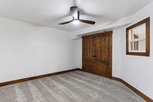 Unfurnished bedroom featuring carpet and ceiling fan