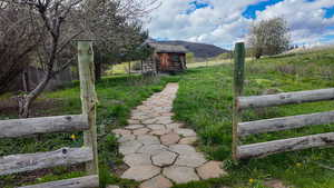 View of yard with a mountain view, an outbuilding, and a view of countryside