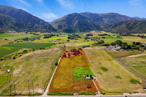Overview of rural landscape with property boundaries highlighted and a mountainous background