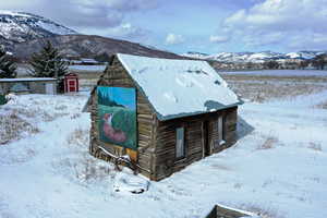 Snow covered structure featuring a mountain view