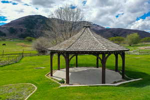 View of property's community featuring a gazebo, a patio, a mountain view, and a view of countryside