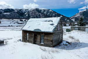 Snow covered structure with a mountain view