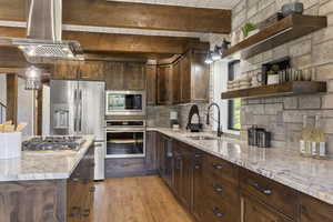 Kitchen featuring dark wood finish cabinets, open shelves, stainless steel appliances, light wood-style floors, and a wooden ceiling with exposed beams