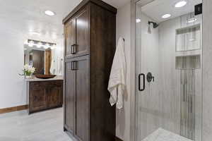 Full bath with vanity and a stall shower