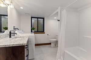 Full bath with vanity, shower / tub combo, recessed lighting, separate washer and dryer, and light wood-style floors