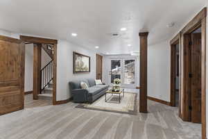Living area featuring light carpet and recessed lighting