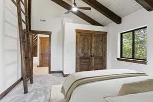 Carpeted bedroom with ceiling fan, a high wooden beamed ceiling, and a closet
