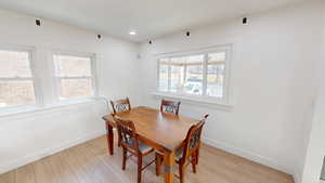 Dining space with light wood-type flooring and recessed lighting