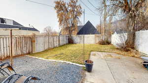 Fenced backyard with a patio