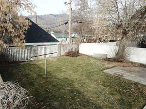 Fenced backyard featuring a mountain view