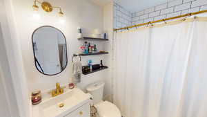 Bathroom with vanity and a shower with shower curtain