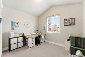 Office area featuring light carpet and baseboards