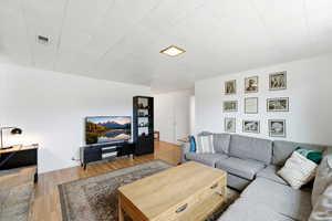 Living area featuring light wood-style flooring and baseboards