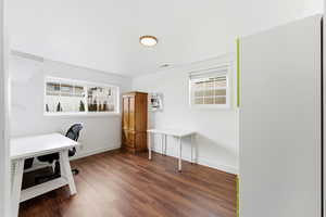 Home office featuring baseboards and dark wood-style flooring