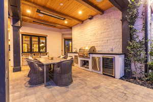 View of patio / terrace with an outdoor kitchen / dining area and beverage cooler