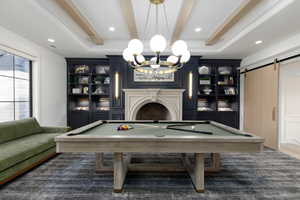 Rec room with a barn door, billiards, recessed lighting, beamed ceiling, and built in features