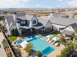 Rear view of property featuring a chimney, a patio area, a fenced backyard, and a residential view