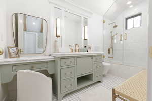 Full bath featuring vanity, tiled shower / bath combo, and recessed lighting