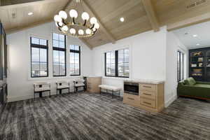 Living area with suspended lighting and beam ceiling