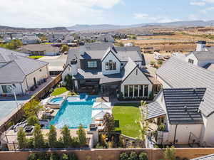 Aerial view of residential area with a mountain backdrop and a pool area