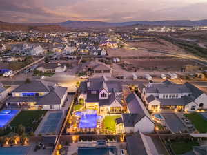 Aerial view of residential area with a pool area and a mountainous background