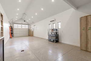 Garage featuring baseboards and recessed lighting