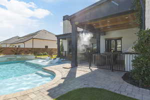 Combined pool / hot tub featuring a patio area and a fenced backyard