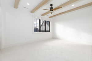 Empty room featuring carpet floors, beamed ceiling, ceiling fan, and recessed lighting