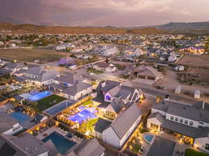 Aerial perspective of suburban area with a pool area and mountains