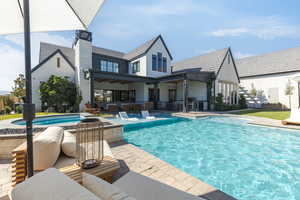 Rear view of property featuring a patio and a chimney