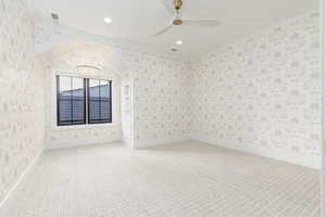 Empty room with ornamental molding, carpet floors, wallpapered walls, recessed lighting, and a ceiling fan