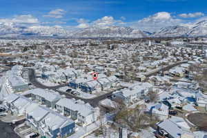 Snowy aerial view with a mountain view and a residential view
