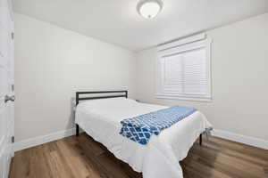 Bedroom featuring baseboards and wood finished floors