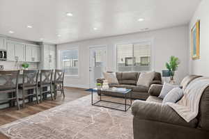 Living room with dark wood-style flooring and recessed lighting