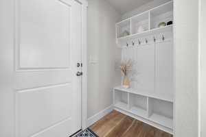 Mudroom featuring wood finished floors and baseboards