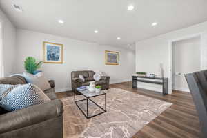 Living area featuring recessed lighting and dark wood finished floors