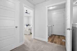 Hallway featuring washer and dryer and carpet flooring