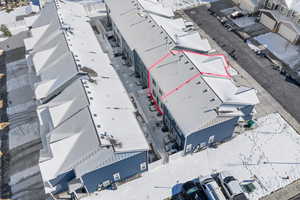 Snowy aerial view with property parcel outlined and a residential view